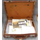 A suitcase containing a collection of first day covers, high value definitive issue presentation