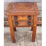 A cast iron book press, on wooden stand, fitted two drawers