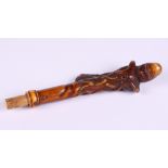 A carved ivory parasol handle, formed as an octopus on a branch, 5 1/2" long