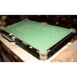 An ebonised miniature billiard table with slate bed and a set of billiard balls, 31" x 17"