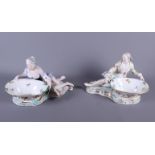 A pair of 19th century Meissen porcelain sweetmeat dishes with male and female reclining supporters,