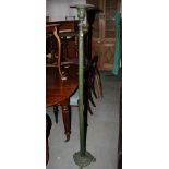 A brass Corinthian column standard lamp, on square stepped base with paw feet