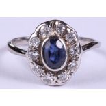 An 18ct white gold, diamond and sapphire cluster ring, size P, 3.2g
