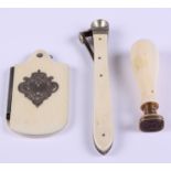 A Victorian ivory aide-memoire with silver inlay, a desk seal with ivory handle and cigar cutter