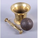 A brass pestle and mortar, two brass hand bells, a cannon ball (fractured) and a cast iron fox