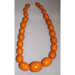 A string of butterscotch amber beads, twenty-three beads ranging in size from 16mm to 32mm approx,