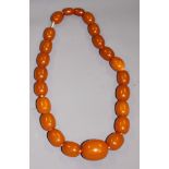 A string of butterscotch amber beads, twenty-three beads ranging in size from 8mm to 28mm approx,