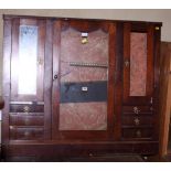 A 19th century mahogany cabinet with central glazed cupboard flanked by smaller mirrored cupboards