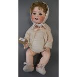 A Heubach & Kipplesdorf bisque headed doll with sleeping eyes, open mouth and jointed composition
