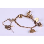 A 9ct gold curb link bracelet with heart-shaped clasp, five charms, various, and a similar smaller