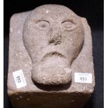 A stone corbel, carved medieval grotesque face