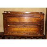 A 19th century oak cabinet, fitted three quarter gallery fitted pigeon-holes, enclosed by two