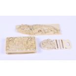 A Japanese ivory carved panel decorated lion and lioness (a/f), a Japanese ivory belt buckle