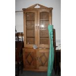 A 19th century pine two-stage bookcase, the upper section enclosed two glazed doors over base fitted