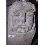 A stone corbel, carved medieval grotesque face