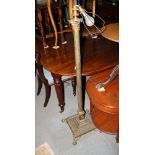 A verdigris finish metal torchere with reeded column, on circular base with paw feet