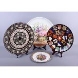 A late Victorian circular pottery wall plaque, painted floral arrangement, 16" dia, and two