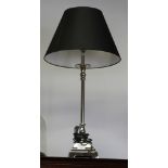 A silvered metal table lamp, on square base with black shade