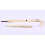 An ivory parasol handle and a turned ivory needle case, 4 1/2" long