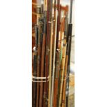 A collection of assorted cane and other fishing rods and fishing rod sections