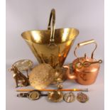 A copper kettle, a brass coal helmet, a brass cream skimmer, a brass trivet and other metalware