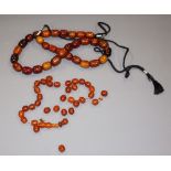 Two sets of amber coloured prayer beads