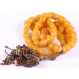 An Oriental graduated amber bead necklace 109g gross