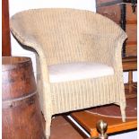 A Lloyd Loom tub back armchair with sprung seat