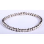 An 18ct white gold tennis bracelet set forty-nine brilliant cut diamonds, in individual hexagonal