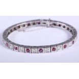An 18ct white gold, ruby and diamond tennis bracelet set thirty-six stones, in individual square