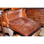 A sloping wooden desk top with panelled back, 24" wide, and a walnut semicircular hall table, on