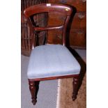 A set of four Victorian mahogany bar back dining chairs with stuffed over seats, upholstered in a
