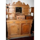 A 19th century pine sideboard, the back fitted central mirror and four open shelves over base fitted