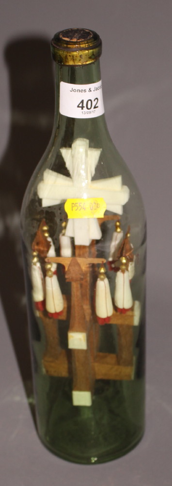 A pilgrim's 19th century Holy Land bone and cypress cross in a bottle souvenir, 11 3/4" high