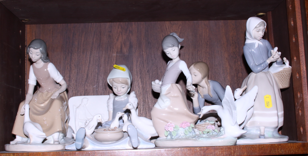 Five Lladro figures of girls feeding geese (two damaged) and a Lladro Collector's Society plaque