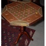 An octagonal chess table with copper and brass decorated top, on tripod base, 29" wide