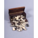 A 19th century prisoner-of-war work carved bone domino set, in fitted case, 5" long