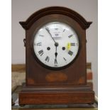 A Georgian style mantel clock, in arched top mahogany case with line and spandrel inlay, white