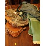 A pair of green waders, a fishing bag and two leather bags