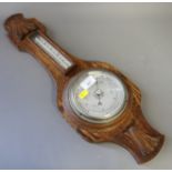 An oak cased anaeroid barometer and an alabaster table lamp