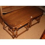 An Ercol 17th century style nest of three elm coffee tables