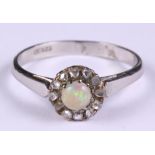 A platinum, opal and diamond cluster ring, size R, 3.7g