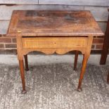 An early 18th century walnut lowboy, the top decorated herringbone stringing, single frieze