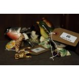 Five Beswick china models of birds, a folding brass cup, in leather case, and a miniature gold