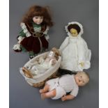 Four porcelain and composition dolls, various