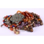 A selection of hardstone and other bead necklaces, an amber and scarab mounted necklace and a