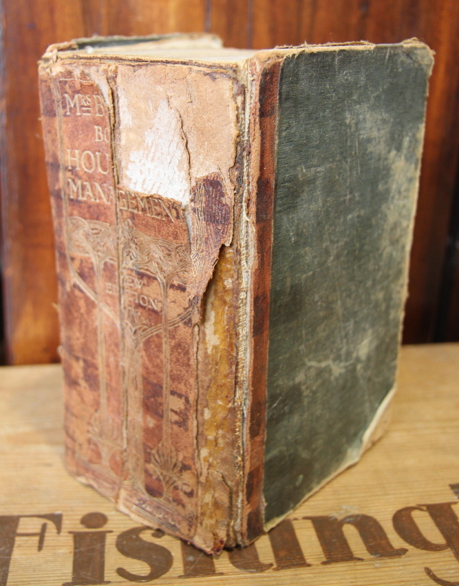 A copy of Mrs Beeton's Book of Household Management (damages) and a quantity of other books