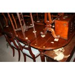 A William IV period mahogany "D" end extending dining table, fitted two centre leaves and hinged