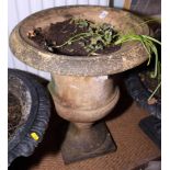 A cast cement garden urn, painted cream, 23" high, and a small metal shell bird bath