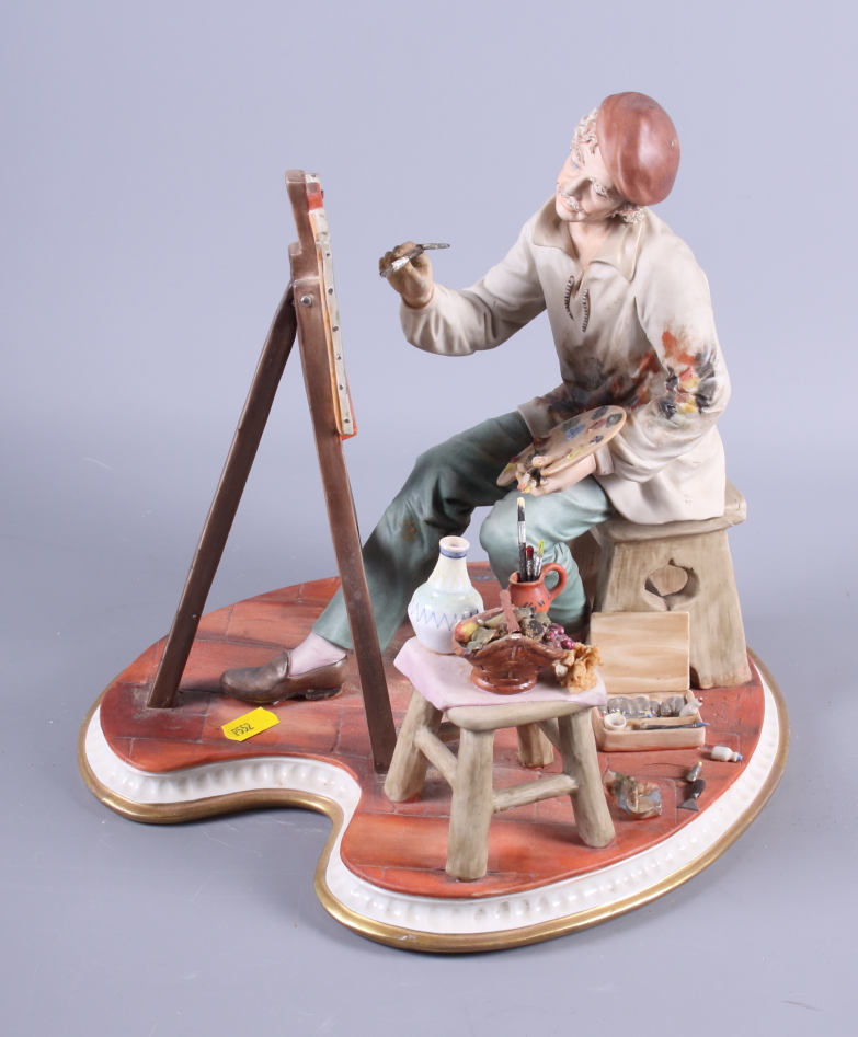A Continental porcelain figure of an artist seated at his easel
